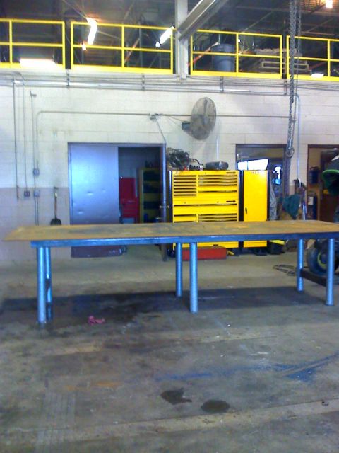 1992 Ford Bronco - A workshop scene a long metal table in the foreground and yellow tool chests in the background.