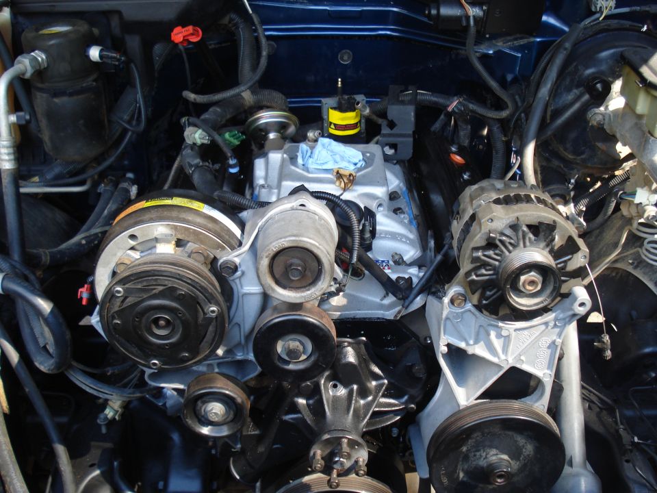Engine bay with V-belt system, alternator, and AC compressor