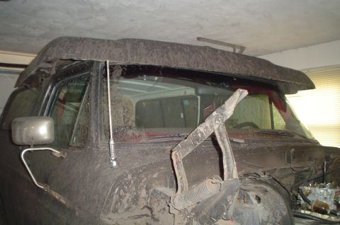 1979 Ford Bronco - Front view of a 1978 Ford Bronco with the hood open, revealing engine parts.