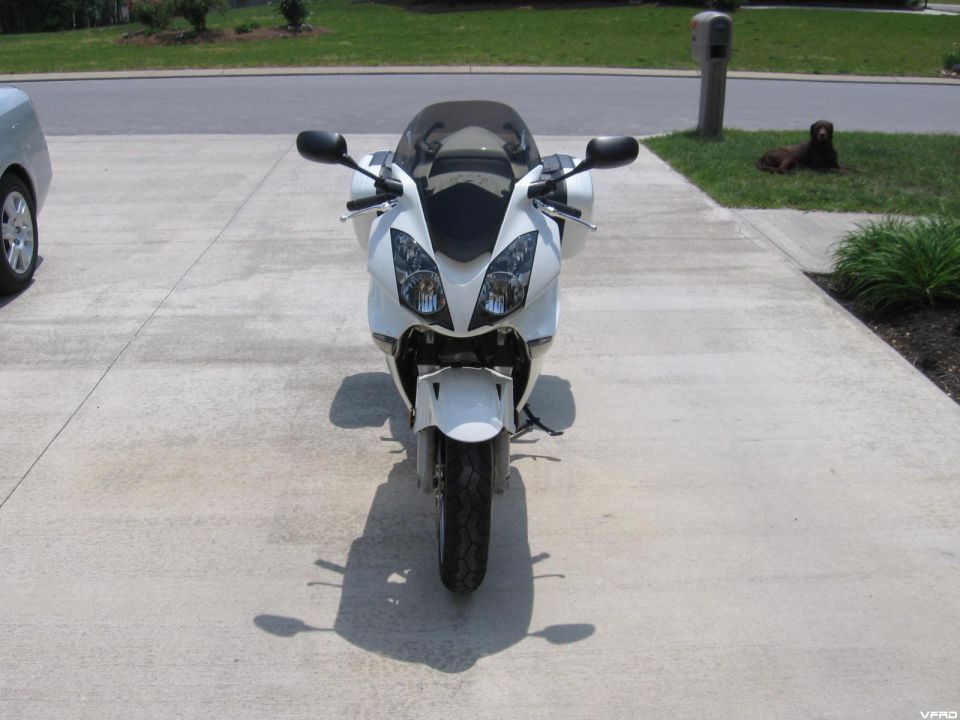 Front view photo of a white Honda VFR motorcycle on a driveway