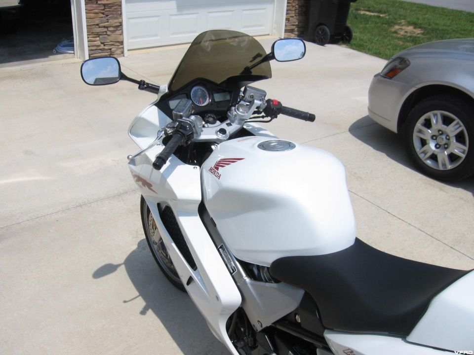Photo of the cockpit and tank of a white Honda VFR motorcycle