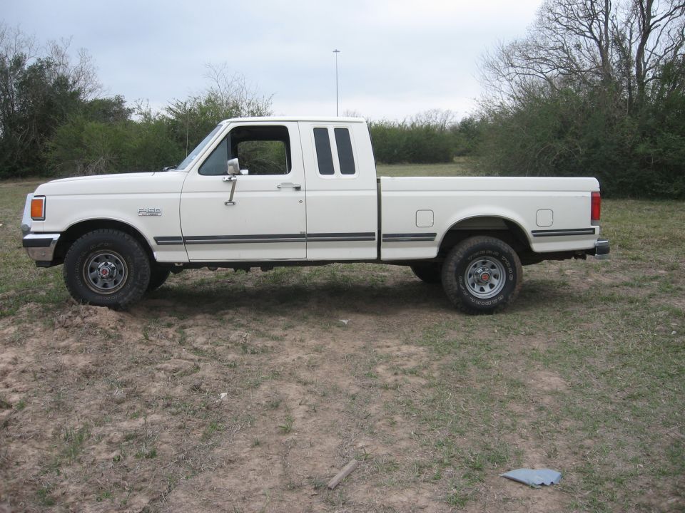 White 1990 Ford F-150 pickup truck side view