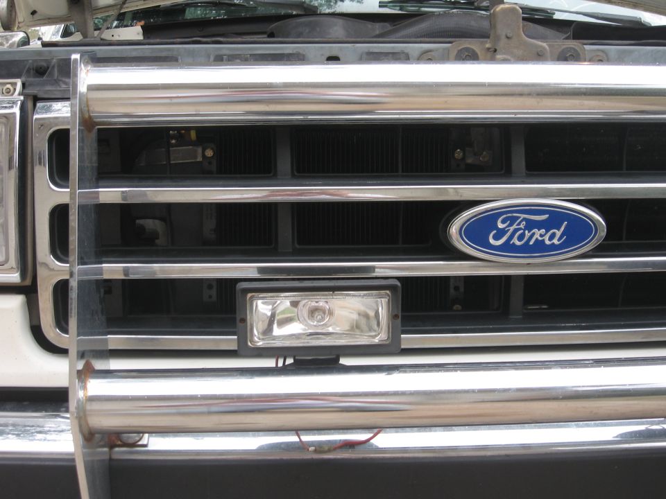 1990 Ford F-150 front grille with chrome bull bar, Ford emblem, and auxiliary light