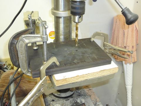 1991 Ford Bronco - A drill press is used to bore a hole in a metal plate secured by clamps and locking pliers.