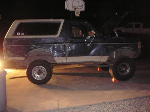 1991 Ford Bronco - This 1991 Ford Bronco, modified with a lifted suspension and oversized tires, is shown with its hood open and resting on jack stands.