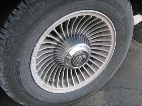 1988 Mercury Grand Marquis - This photo shows a close-up of a Mercury wheel and tire, with the Mercury logo visible on the hubcap.