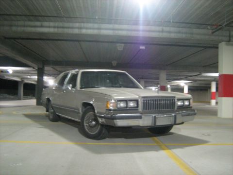 1988 Mercury Grand Marquis - This 1988 Mercury Grand Marquis is captured from the front in a dimly lit parking garage.