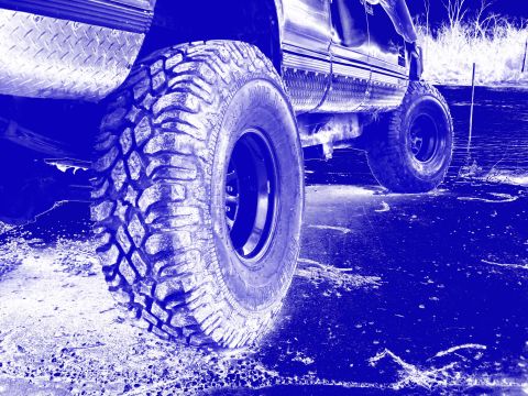 1990 Ford F-250 - Off-road truck tires and fender detail. The vehicle's year is not discernible from this view.