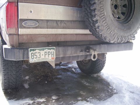 1993 Ford Bronco - The rear of a brown 1993 Ford Bronco is visible, complete with a spare tire and a Colorado license plate.
