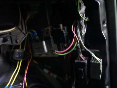 1996 Ford Bronco - This image shows a tangle of wires and electrical relays within a vehicle's interior.