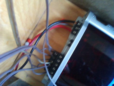 1996 Ford Bronco - Close-up of a car audio amplifier and its wiring, mounted inside a vehicle.