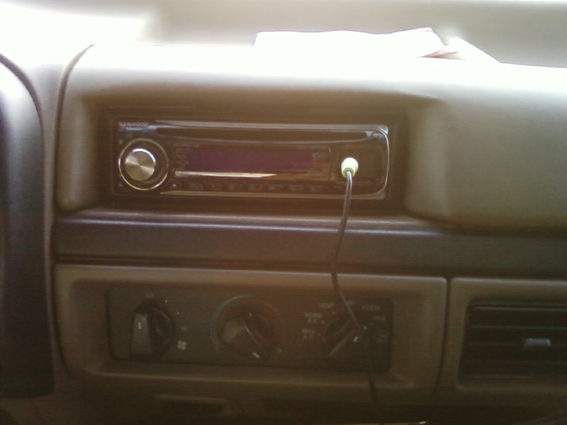 Kenwood aftermarket CD stereo in a truck dashboard with HVAC controls