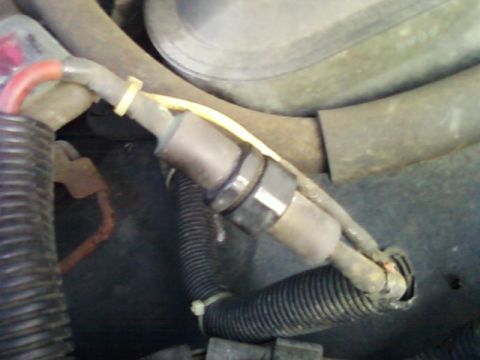 1996 Ford Bronco - Close-up of an oxygen sensor and its associated wiring harness.