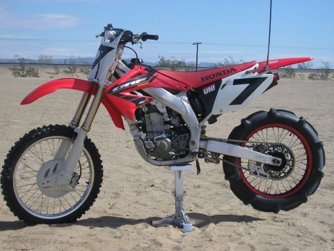 1900 Honda Big Red - This Honda CRF dirt bike is equipped with a sand tire for off-road riding.
