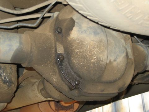 2004 Ford F-150 - Underside view of a dirty rear differential and driveshaft, showing signs of an oil leak.
