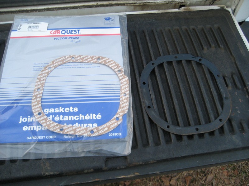 Carquest Victor Reinz gaskets package and a separate rubber seal on a truck bed
