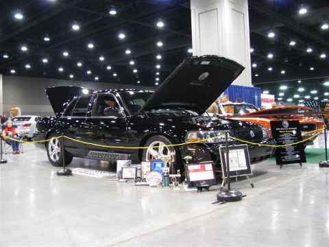 2003 Mercury Marauder - A black 2003 Mercury Marauder is displayed with its hood open, surrounded by trophies at a car show.