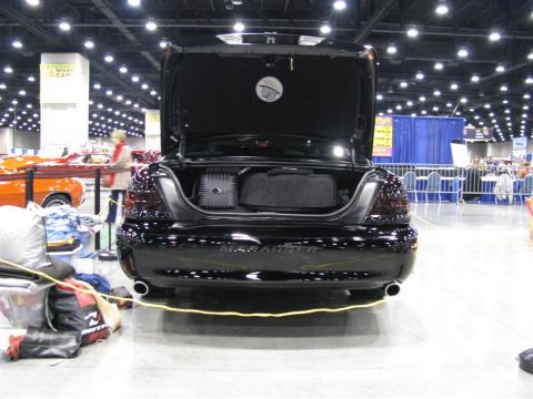 2003 Mercury Marauder - Rear view of a black 2003 Mercury Marauder at a car show, with its trunk open.