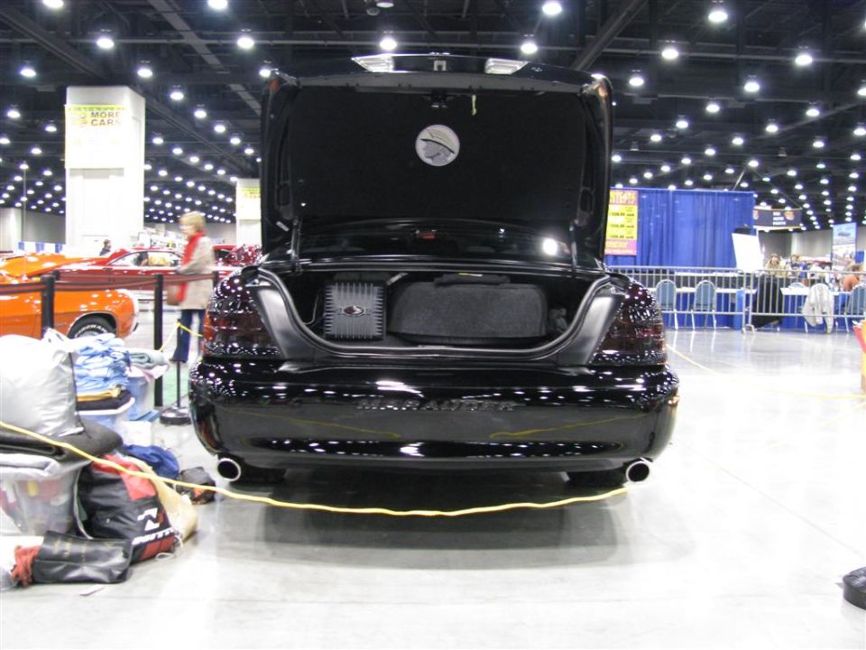 Black 2003 Mercury Marauder rear view with trunk open, showing audio equipment and spare tire