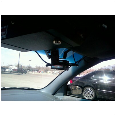 2000 Mercury Grand Marquis - A radar detector is mounted to the interior windshield of a vehicle.