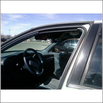 2000 Mercury Grand Marquis - Interior view of a car's dashboard and steering wheel, with a second vehicle seen through the passenger side window.
