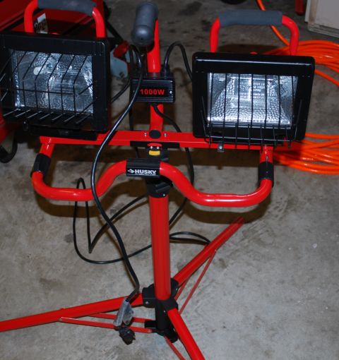 2008 Jeep Wrangler - A red portable work light with two lamps is set up on a tripod stand.