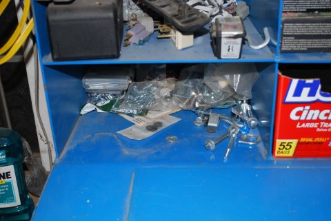 2008 Jeep Wrangler - A blue toolbox is filled with assorted hardware, fasteners, and supplies, including a box of trash bags.