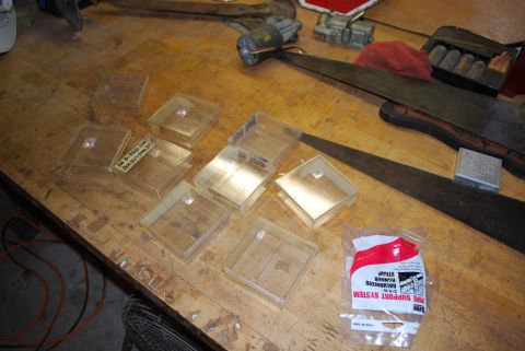 2008 Jeep Wrangler - Various items, including clear plastic containers and tools, are laid out on a wooden workbench surface.