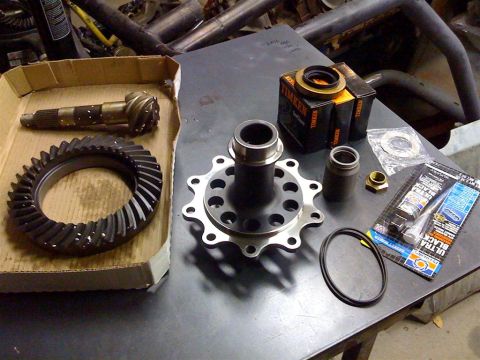 1987 Suzuki Samurai - Differential components including a ring and pinion gear set, carrier, and Timken bearings are laid out on a metal surface.