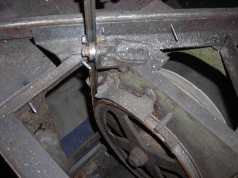 1995 Ford Bronco - Detail of a band saw's mechanical parts, including the blade and pulley system.