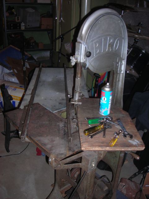 1995 Ford Bronco - A band saw is shown with tools on its work surface, including a spray can and wrenches.