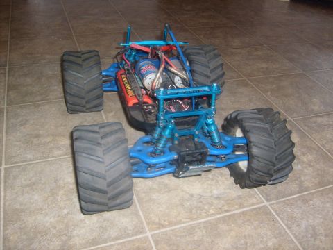 1989 Ford Bronco - This remote control monster truck is blue with large tires and visible mechanical parts.
