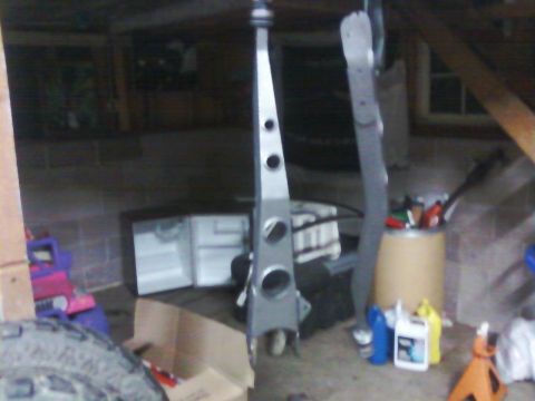 1991 Ford Bronco - A silver suspension component is visible in a cluttered garage setting.