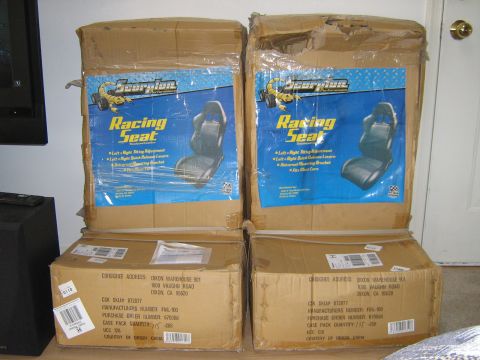 1990 Ford Bronco - Two boxes containing Scorpion Racing Seats are stacked, with shipping labels visible on the lower boxes.