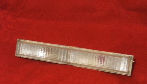 1989 Ford Bronco II - A single clear plastic marker light is shown against a red textured background.