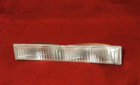 1989 Ford Bronco II - A clear turn signal lens is shown against a red background.