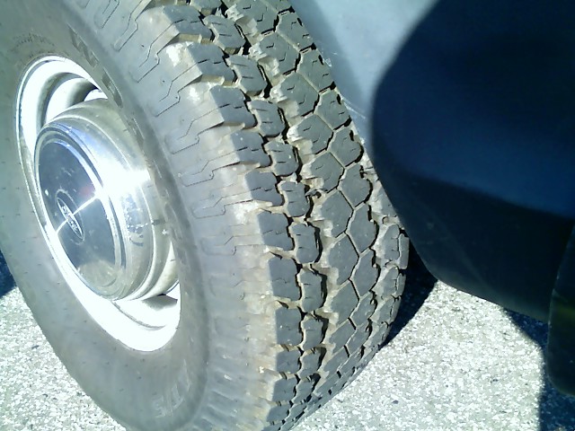 Close-up of a tire and chrome hubcap