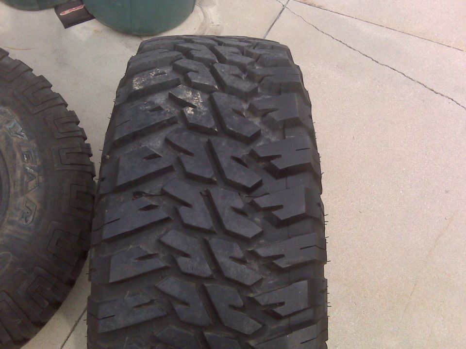 Tread face of an aggressive mud-terrain tire on concrete