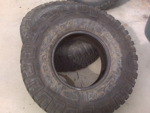 1985 Ford Bronco - Stack of Goodyear Wrangler tires, showing the aggressive tread pattern.