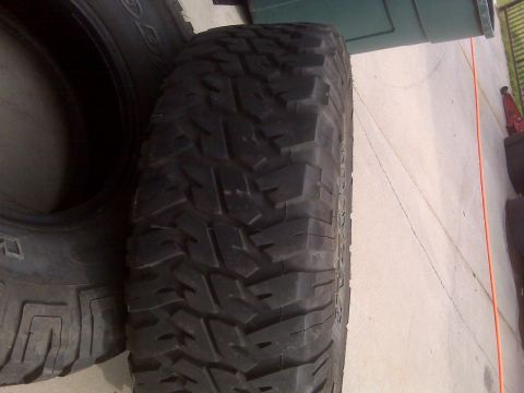 1985 Ford Bronco - A close-up view of a tire with a tread design, likely for off-road use.