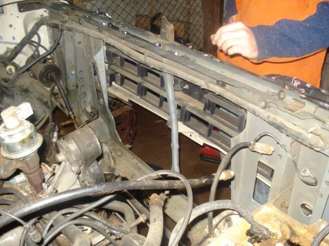 1991 Ford Bronco - Close-up view of the engine bay of a 1991 Ford Bronco, showing various engine components, wiring, and the radiator support structure. A per…