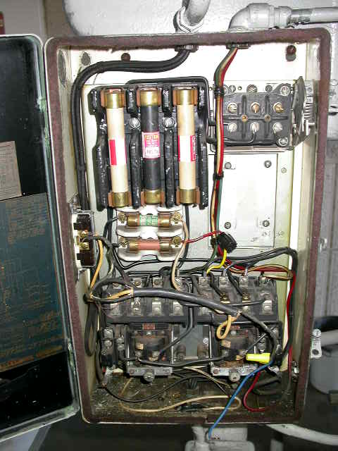 1990 Ford Bronco - The image shows an open electrical control box with fuses, wires, and relays. The interior of the box appears dusty and contains various el…