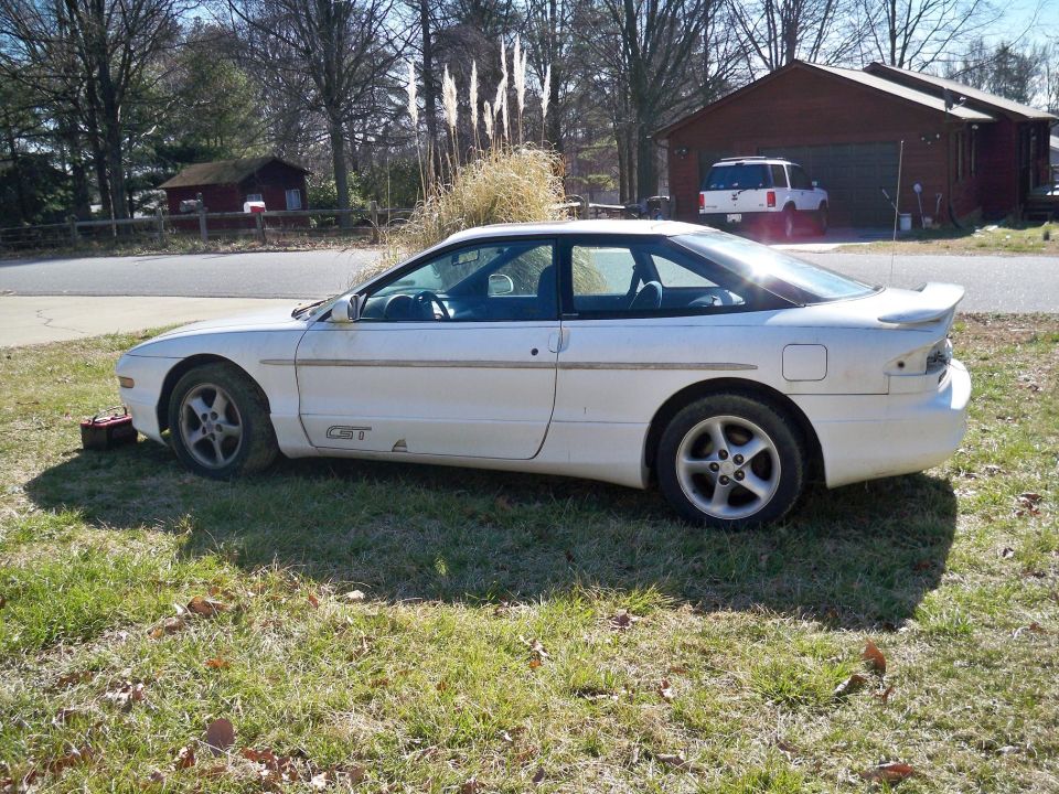 White 1995 Ford Probe GT parked on grass