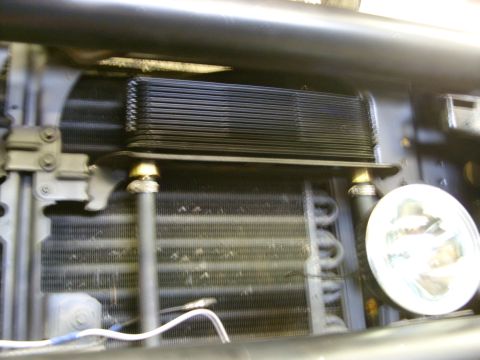 1988 Ford Bronco - A close-up view of the front of a vehicle, showing an oil cooler mounted in front of the radiator. The vehicle appears to be a 1988 Ford Br…