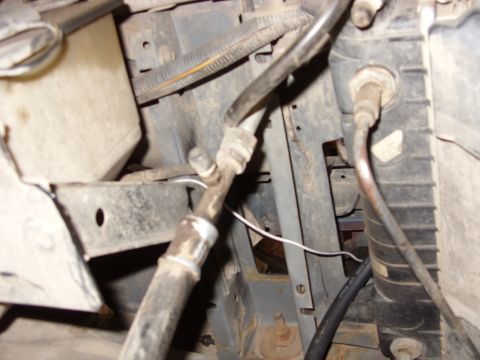 1988 Ford Bronco - This image shows a close-up view of engine bay components, including a radiator, hoses, and wiring. The parts appear to be dusty and show s…
