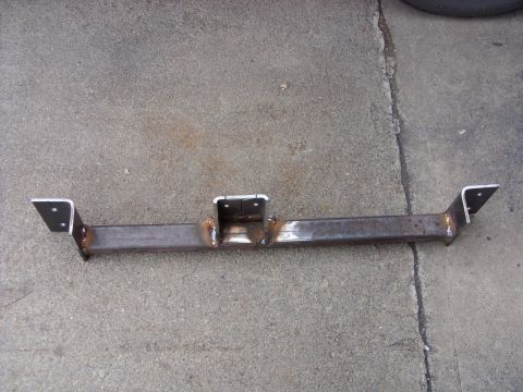 1988 Ford Bronco - A custom steel fabricated bracket, likely for a trailer hitch or suspension component, is shown lying on a concrete surface. The bracket ha…