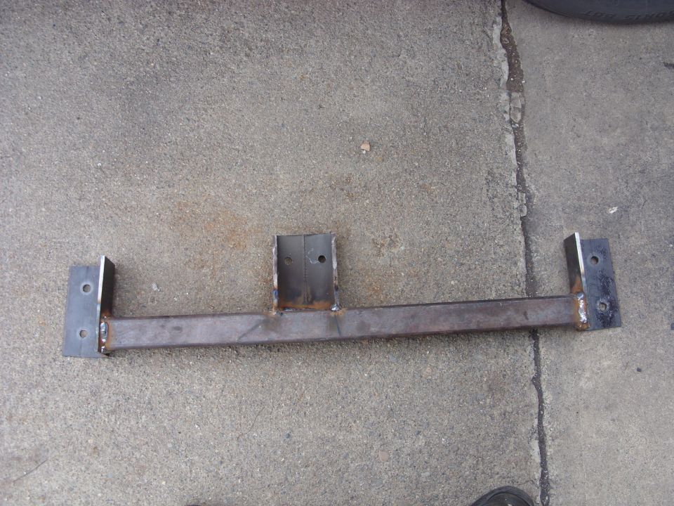 Custom steel bracket with two mounting plates on concrete