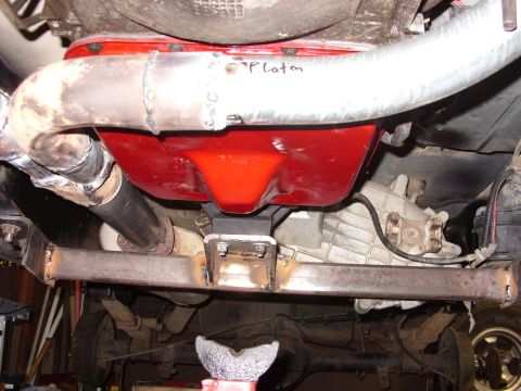 1988 Ford Bronco - Custom exhaust work visible on the undercarriage, with handwritten text on a pipe and a bright red oil pan.