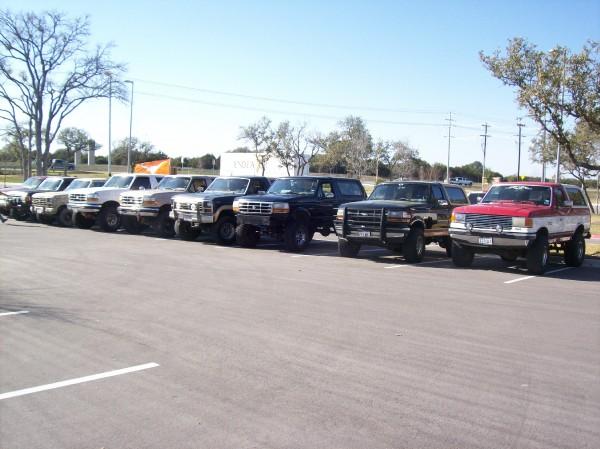 Line of Ford Bronco SUVs parked in a lot.