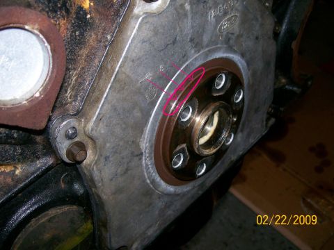 1995 Mercury Grand Marquis - Close-up of the rear face of a Ford engine with the transmission removed, showing the crankshaft flange with its bolt holes and the rear co…